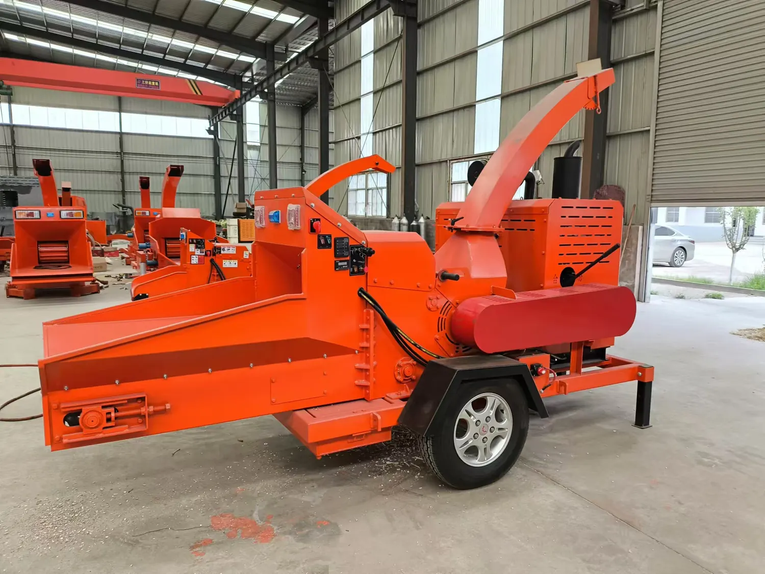 Compact red Cronus branch chipper in a workshop
